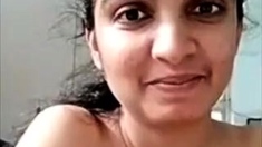 Horny busty indian milf strips nude to show round tits