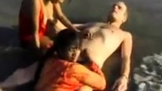 2 Indian girls with white guy in beach have fun blowjob..