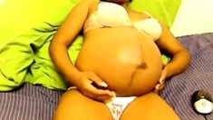 Heavily pregnant black cam chick